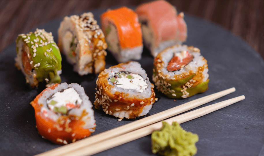 sushi rolls on a plate with chopsticks