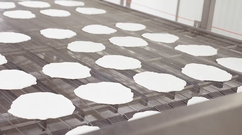 Egglife wraps on a conveyor belt