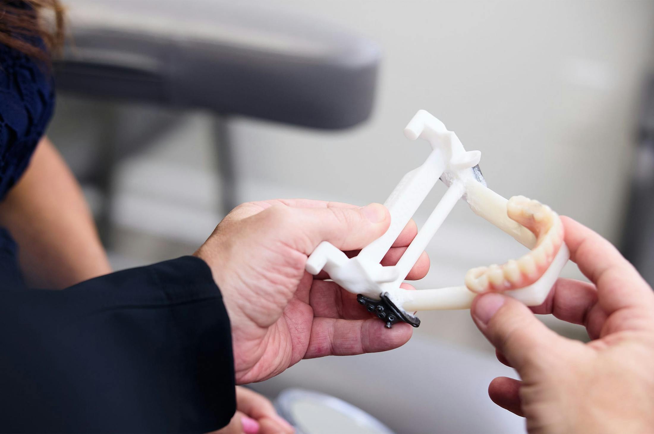 a person holding a prosthetic jaw