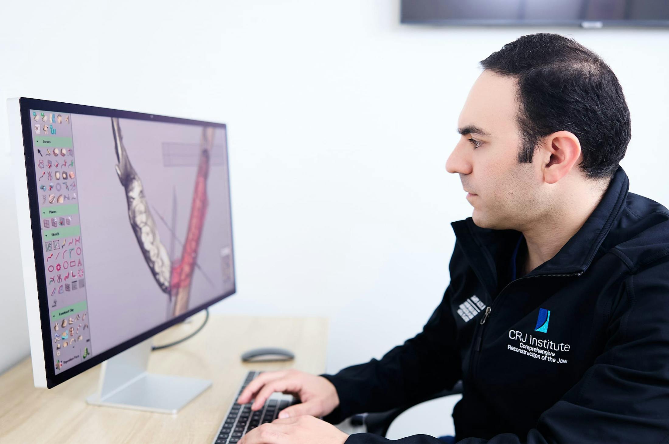 Dr. Azzi looking a scan on computer