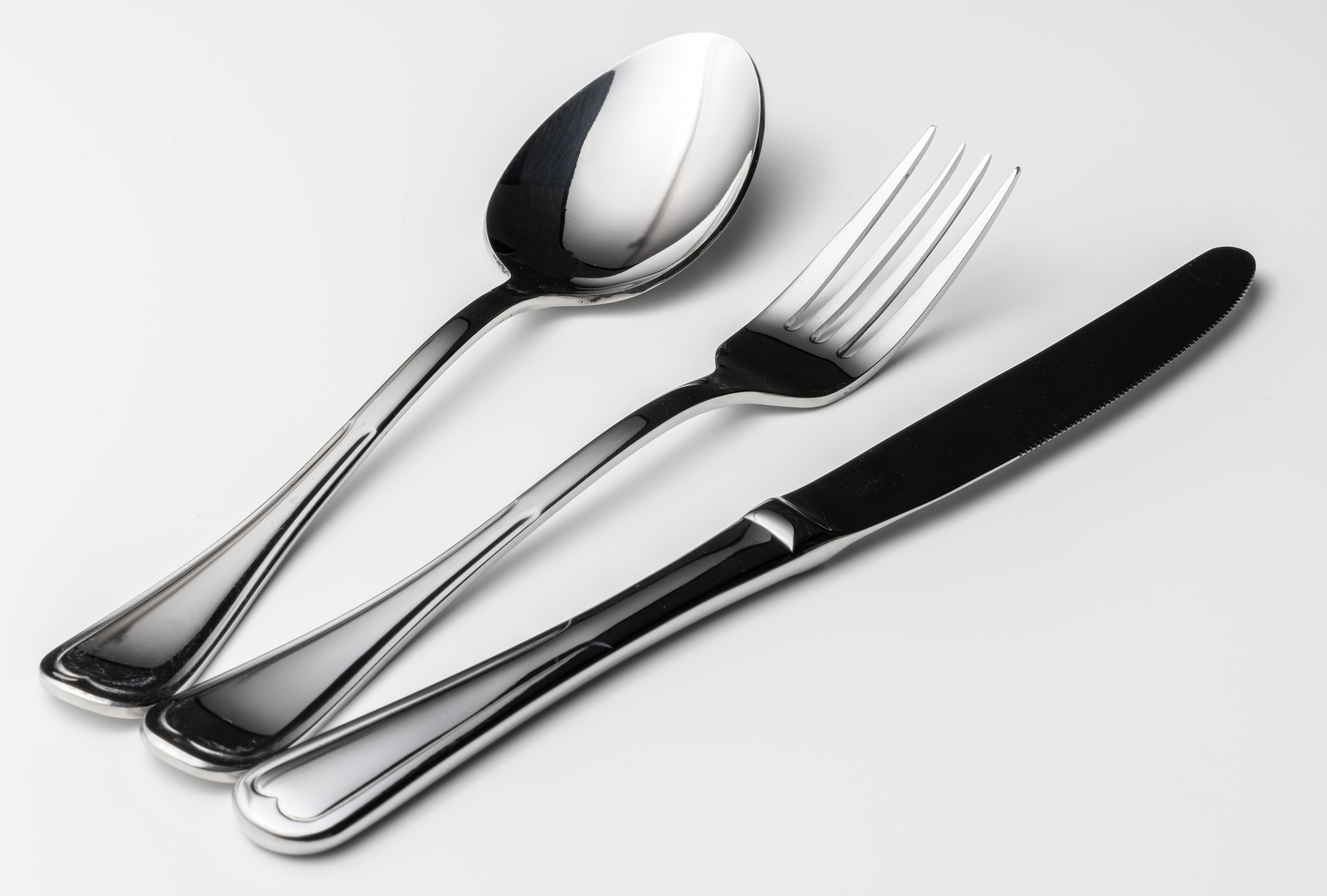Place setting of polished hospitality flatware
