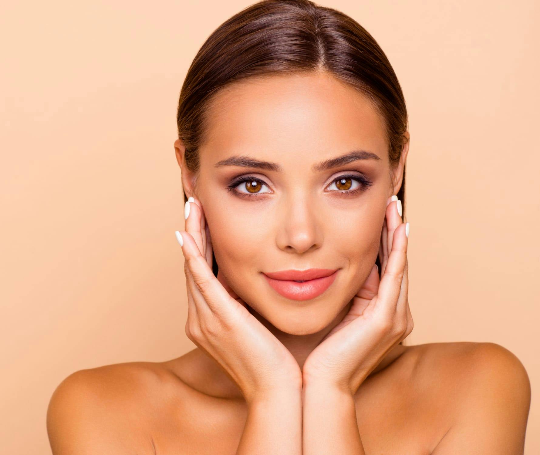 Woman smiling and touching face
