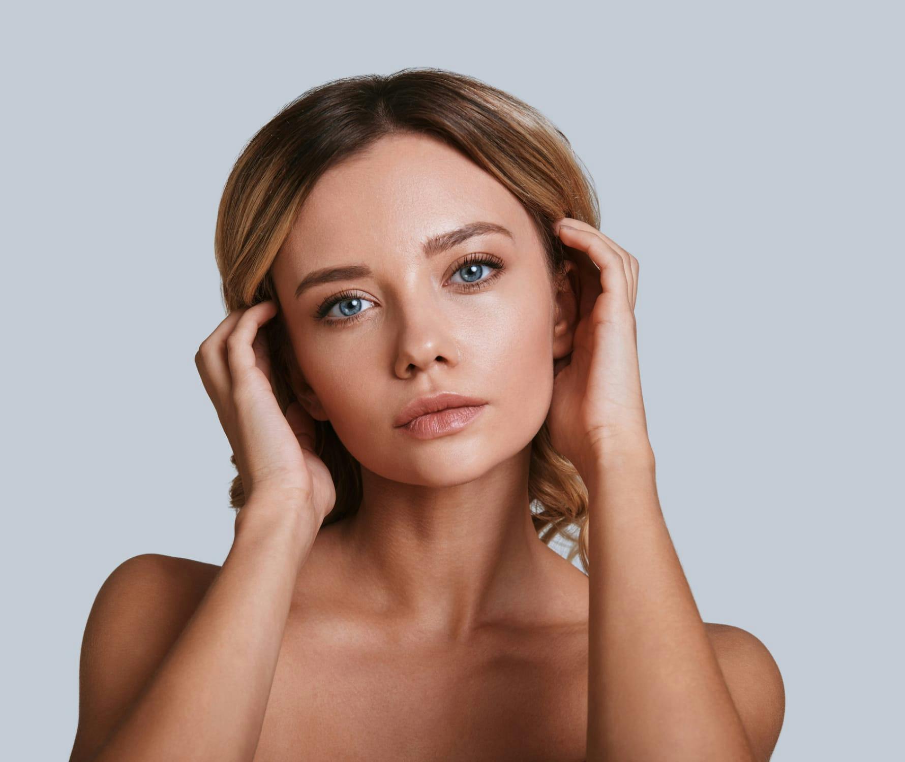 Woman brushing hair behind ears