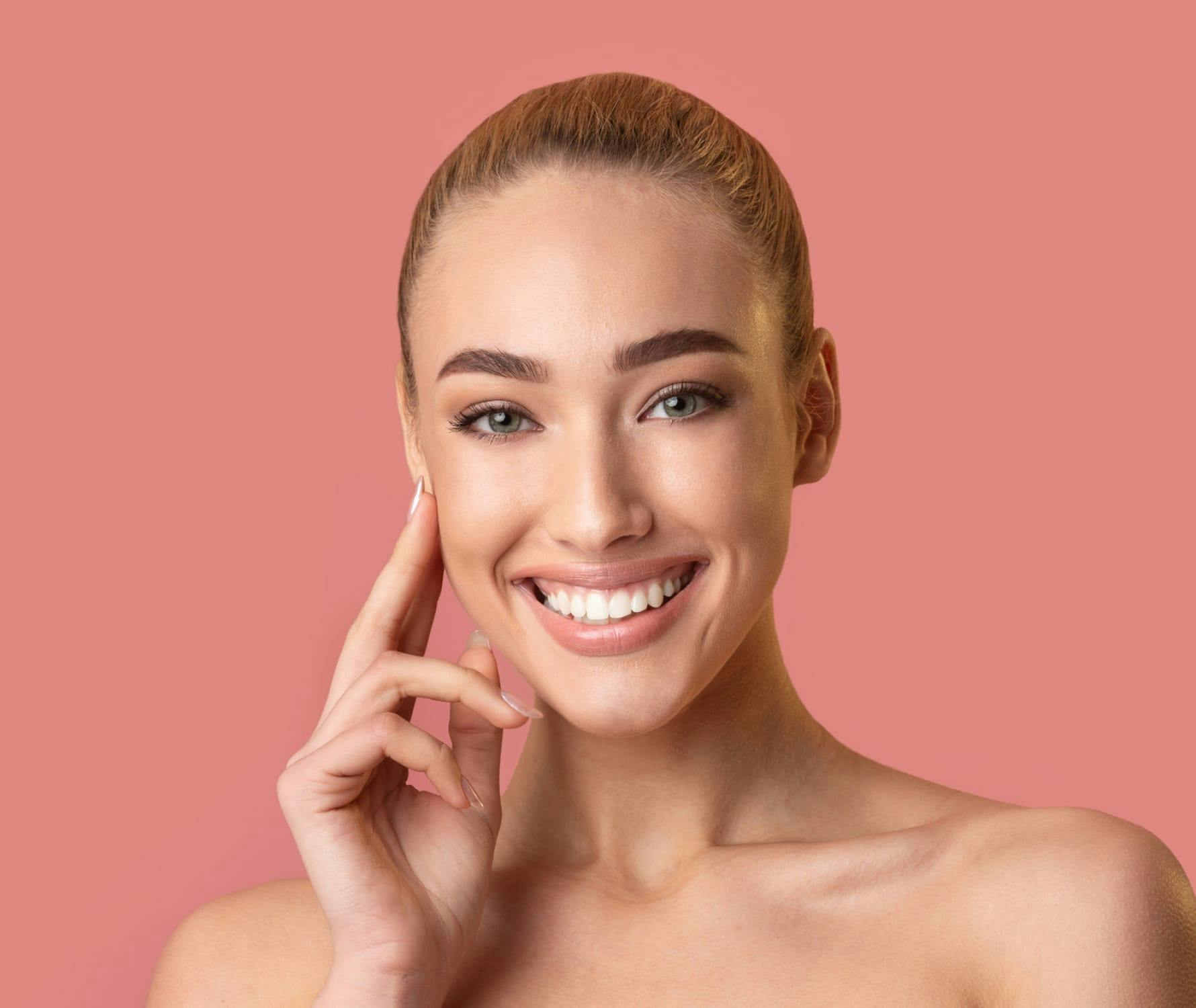 Woman smiling with hand on face