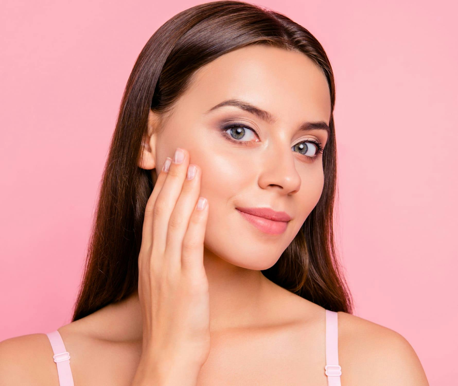 Woman touching face and smiling
