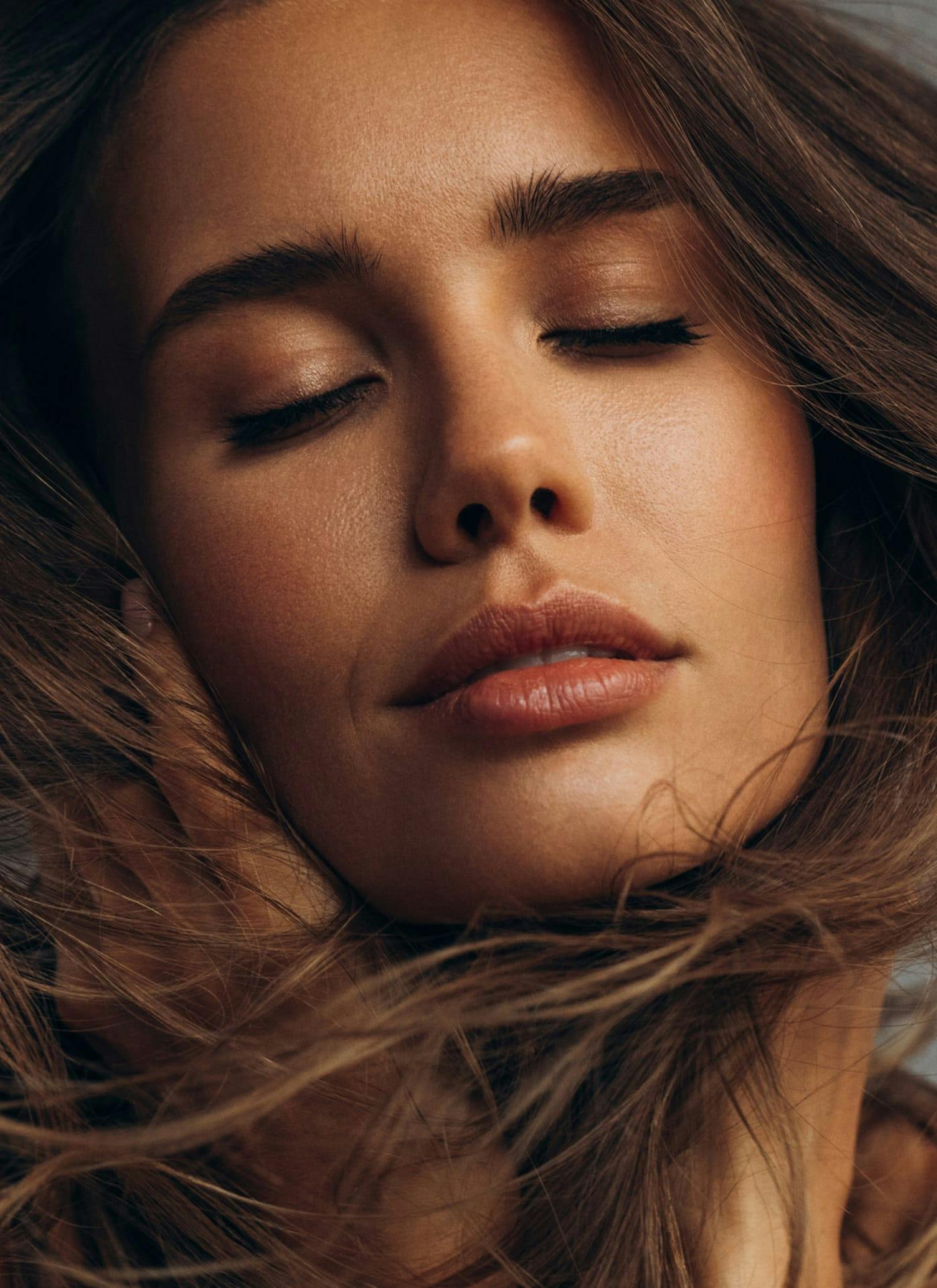 Woman with eyes closed smiling