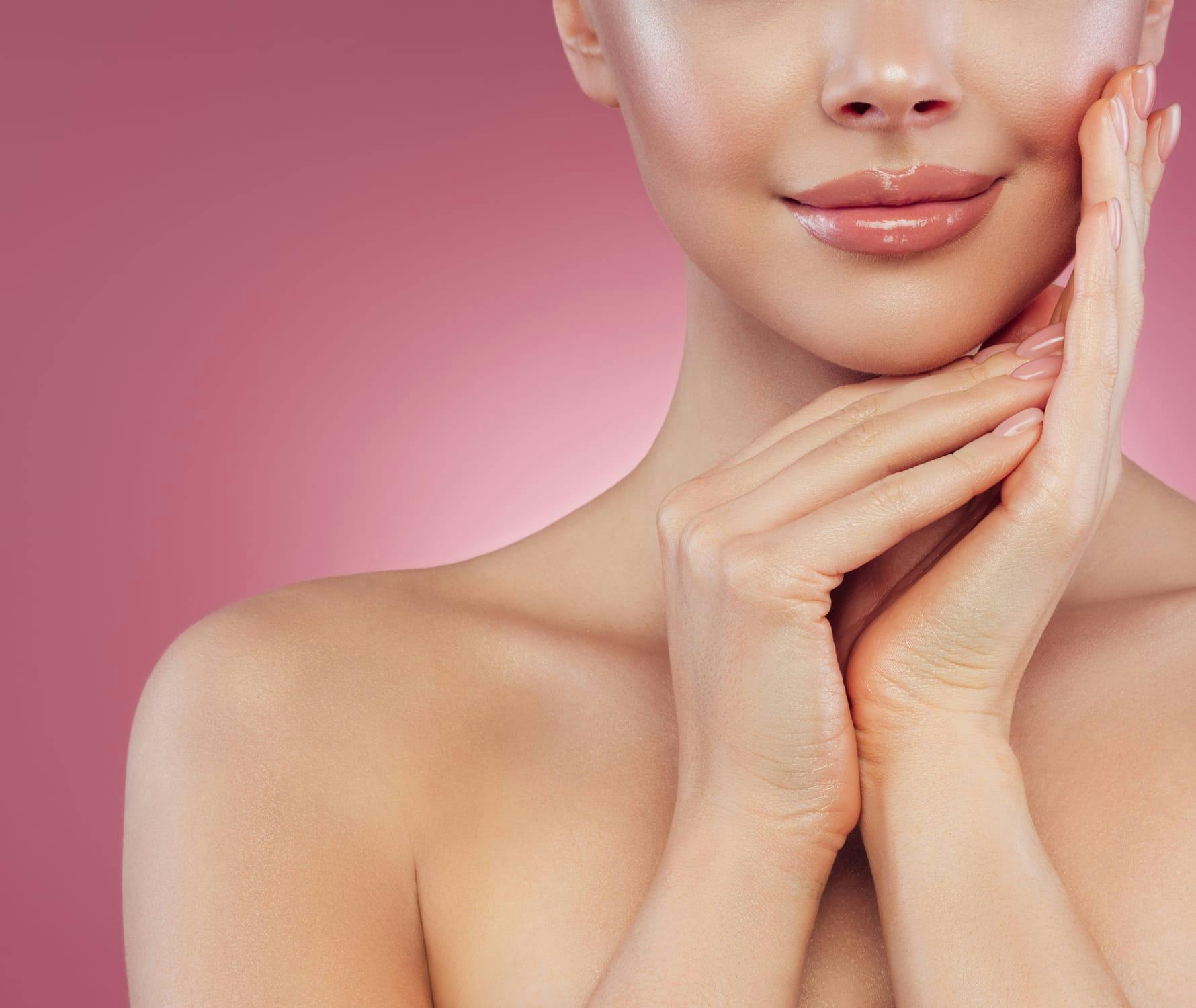 Woman smiling with hands on face