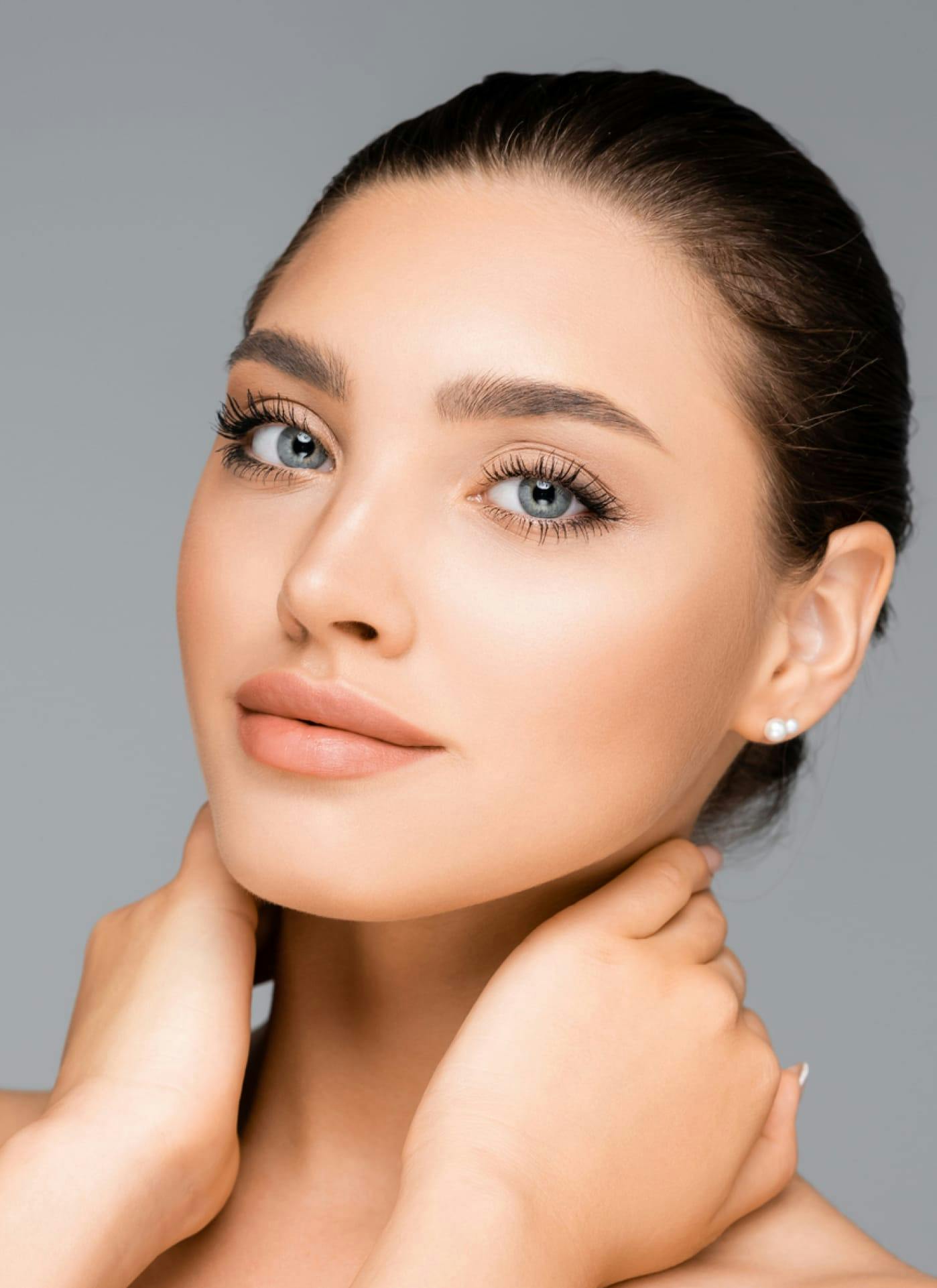 Woman smiling holding neck