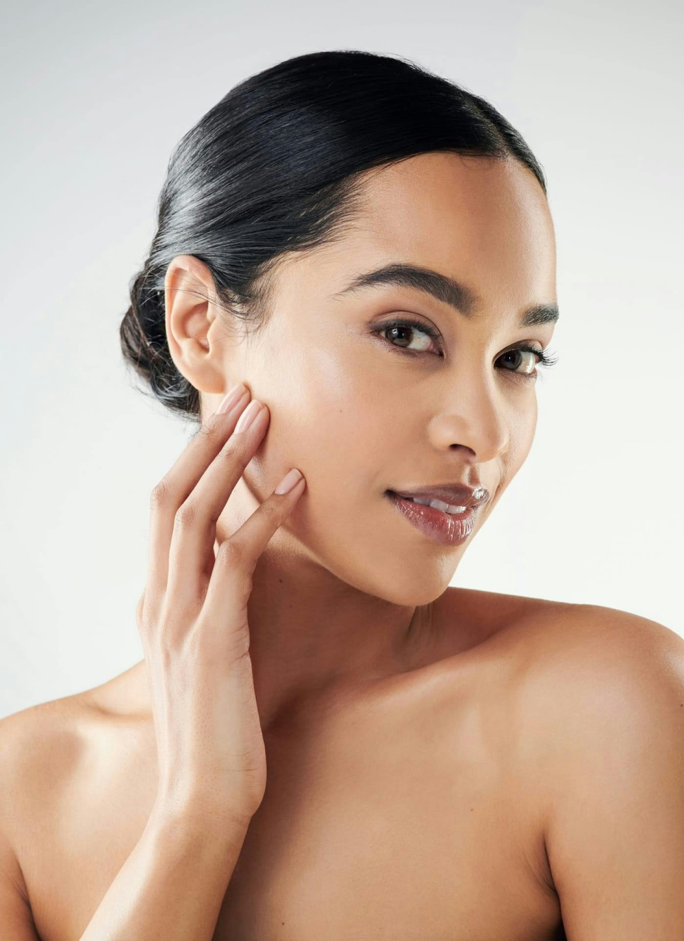 woman smiling touching her face