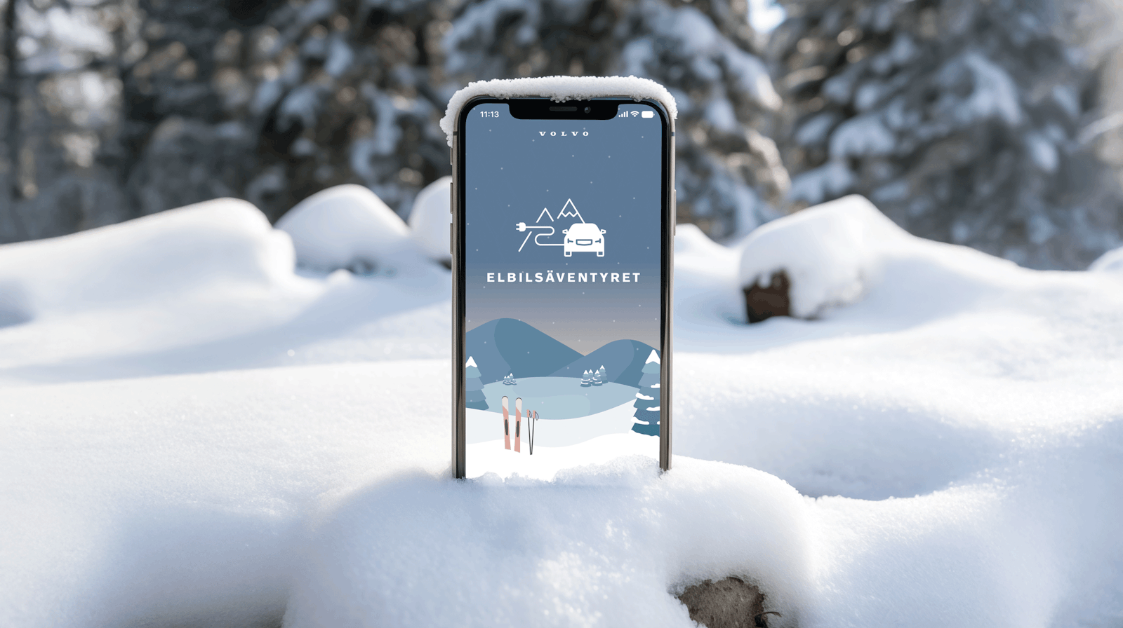 iPhone sticking out of the snow showing the entry screen of Elbilsäventyret.