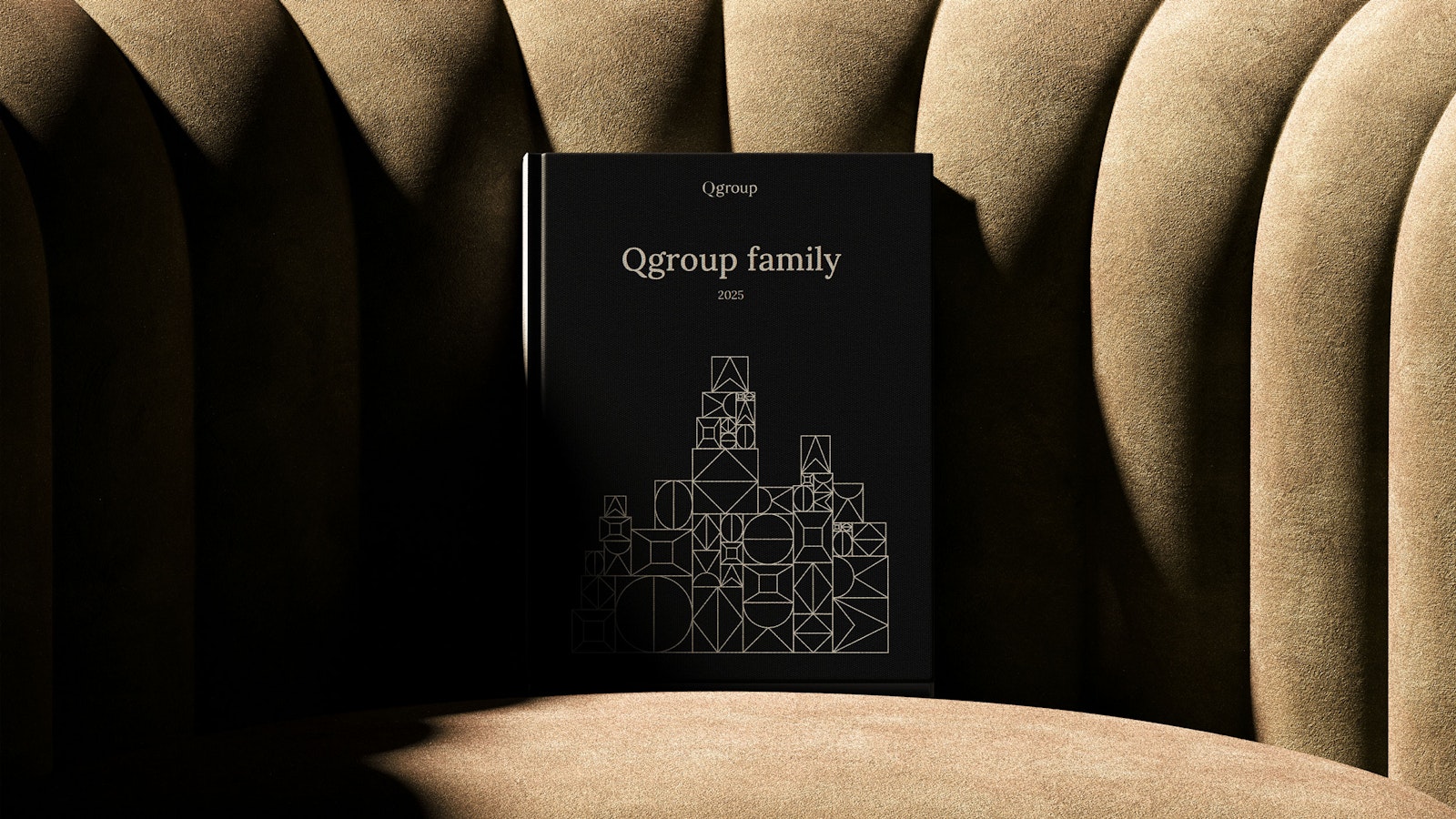 Qgroup family book on a sofa.