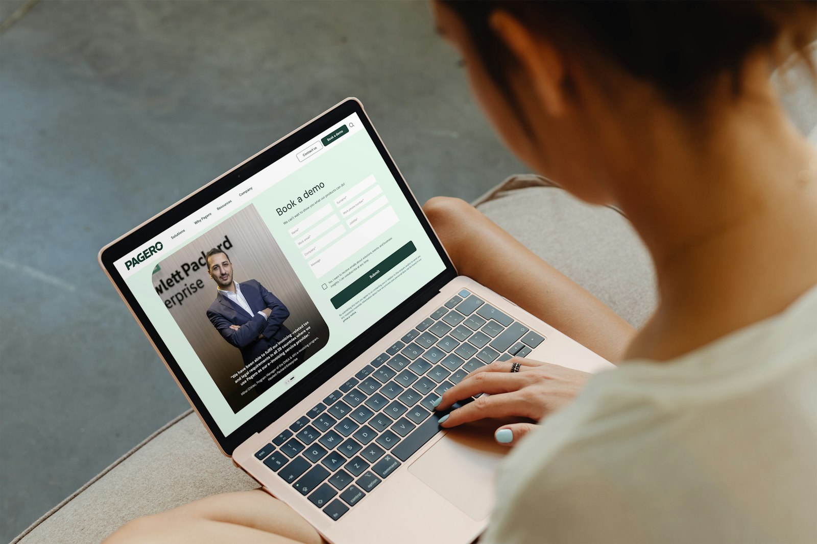 Woman looking at her computer screen displaying the Pagero website.