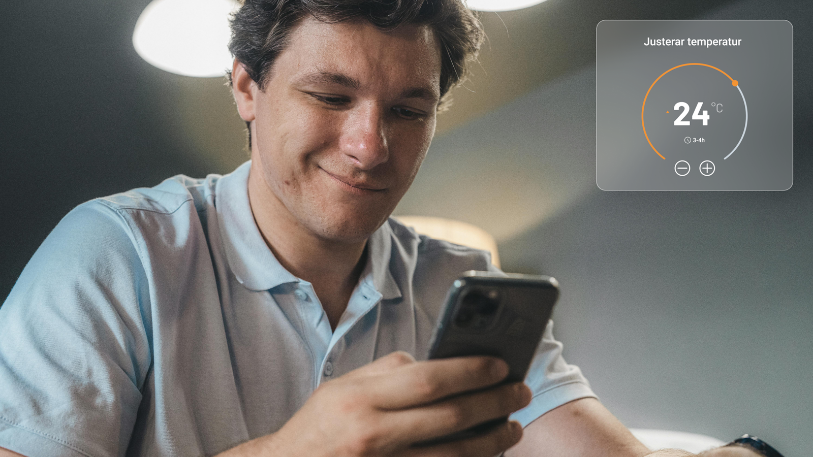 Man looking down at his phone, adjusting the temperature through the LK app.