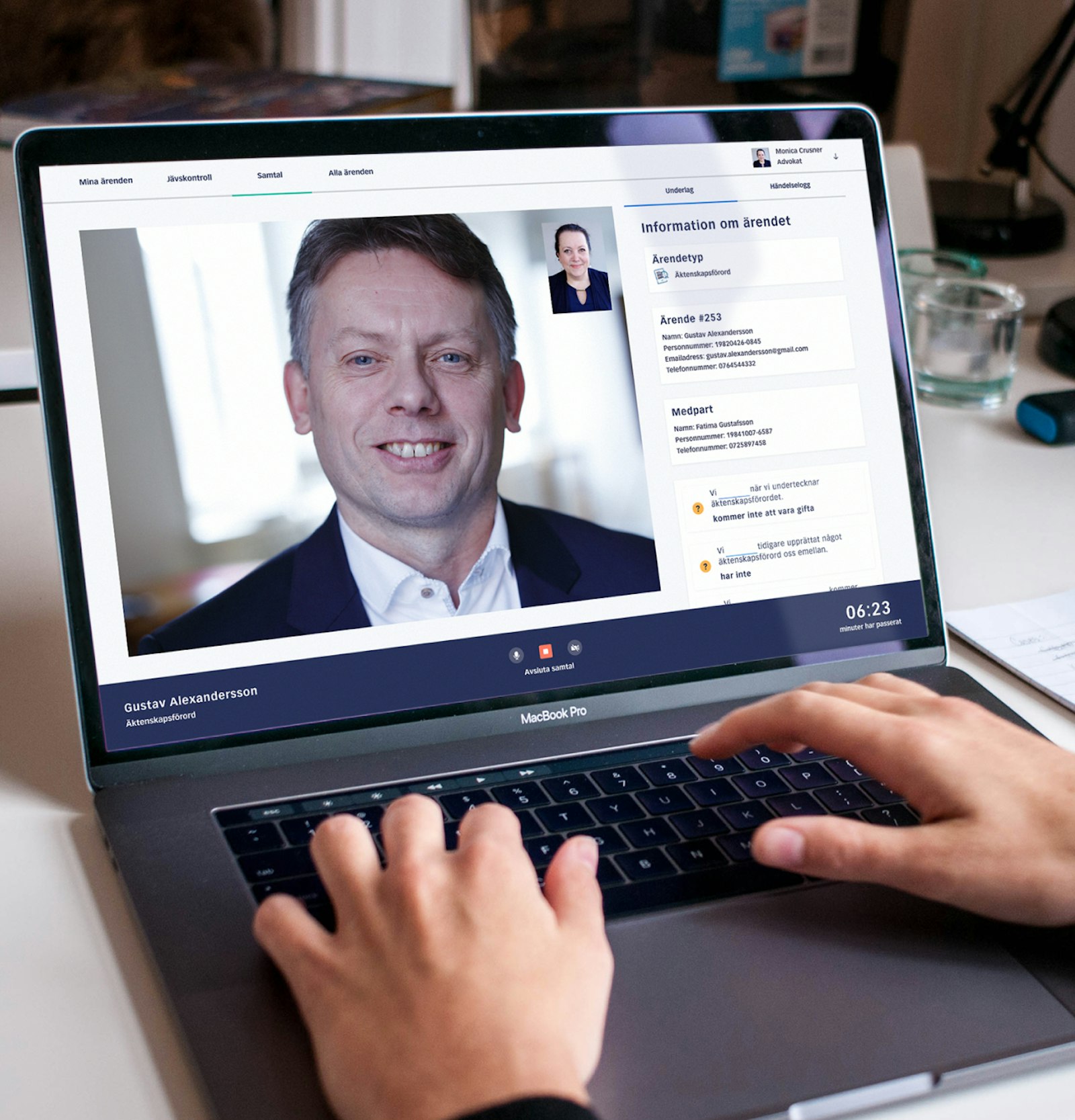 Hands on a laptop keyboard during a video call with a man shown on the screen, displaying a legal case interface.