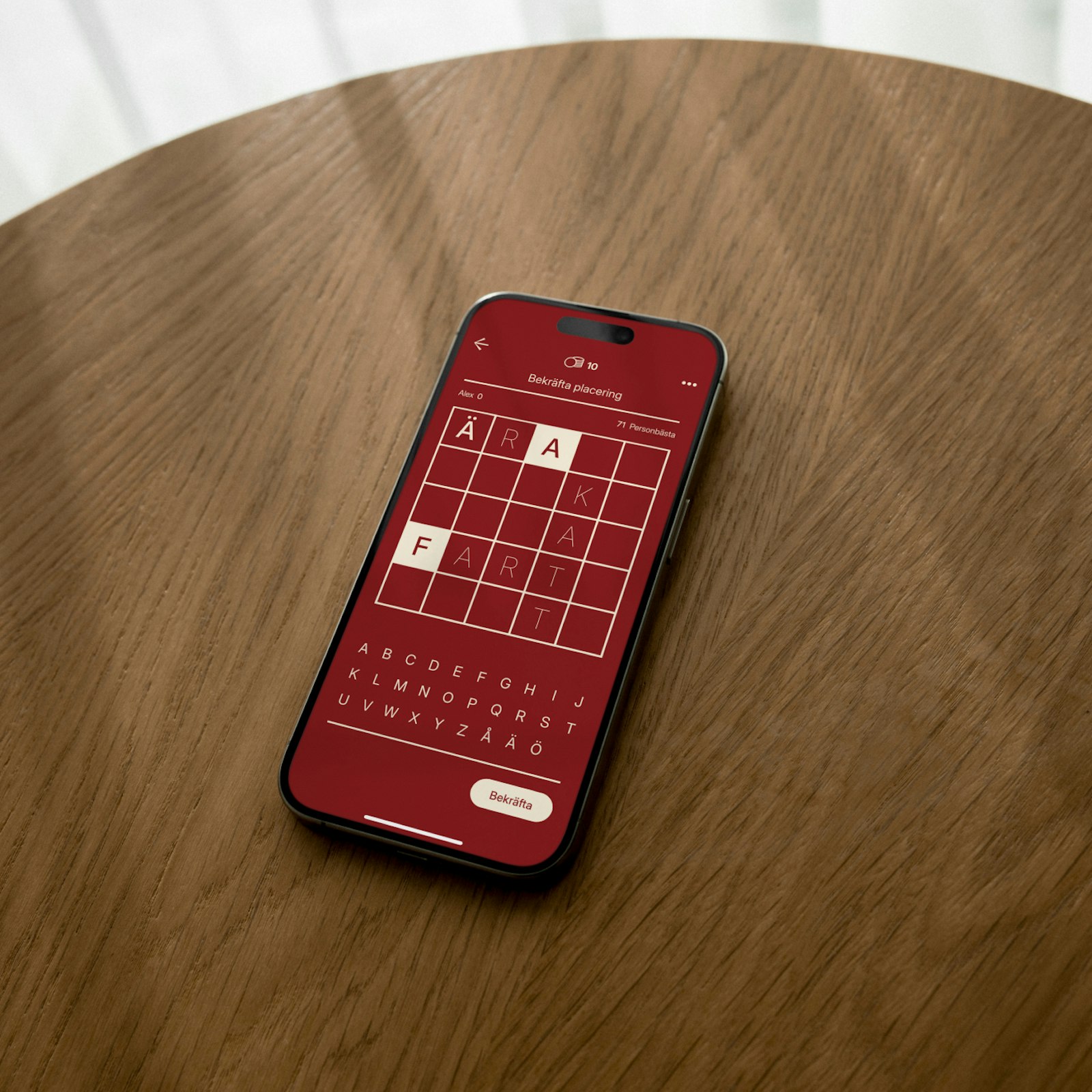 Smartphone displaying a word puzzle game with letters arranged in a grid.