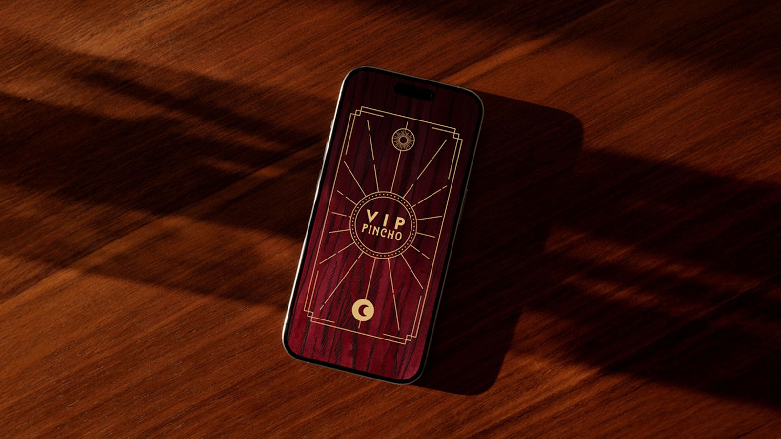 Phone case with a red wood design featuring 'VIP PINCHO' in gold lettering.