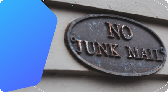 A "no junk mail" metal plaque on a wall.