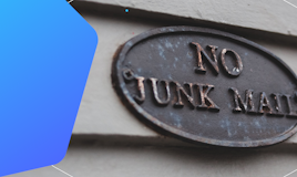 A "no junk mail" metal plaque on a wall.