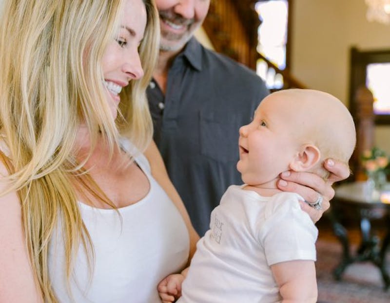 people holding a baby