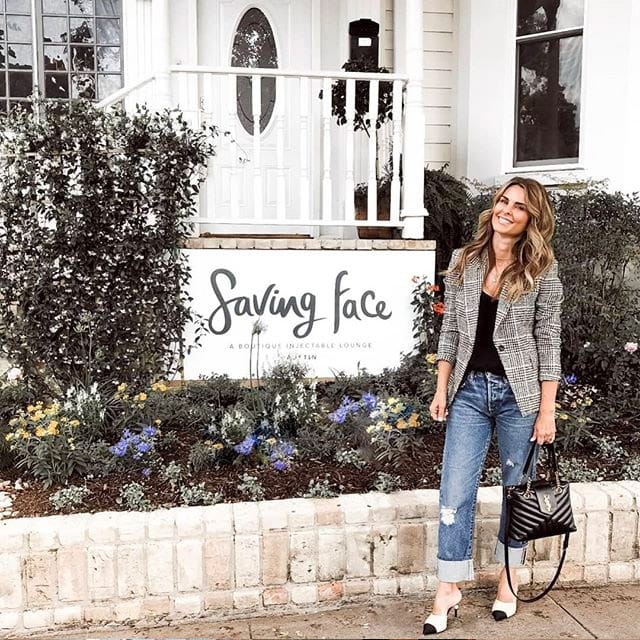 woman posing in front of Saving Face sign