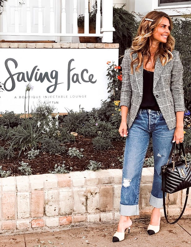 woman standing in front of Saving Face sign