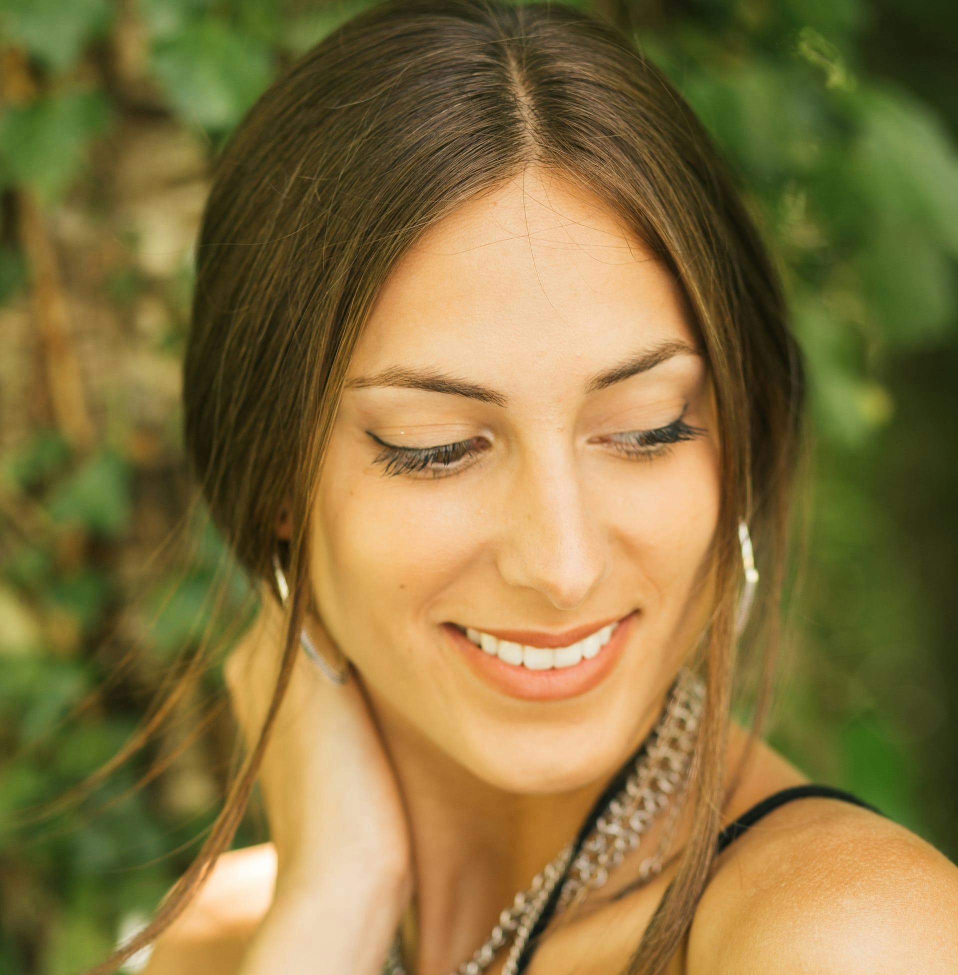 Woman outside with her hand on her neck