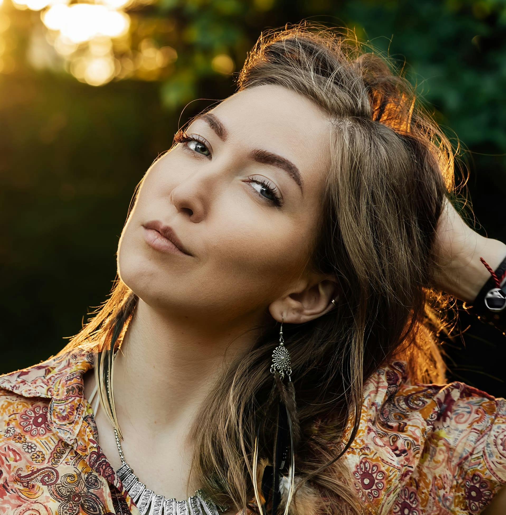 woman outside with her hand on back of her head