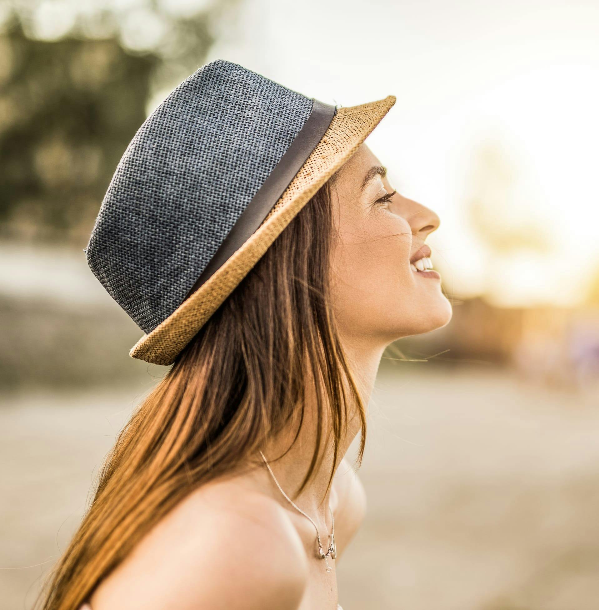 side profile of woman wearing a hat