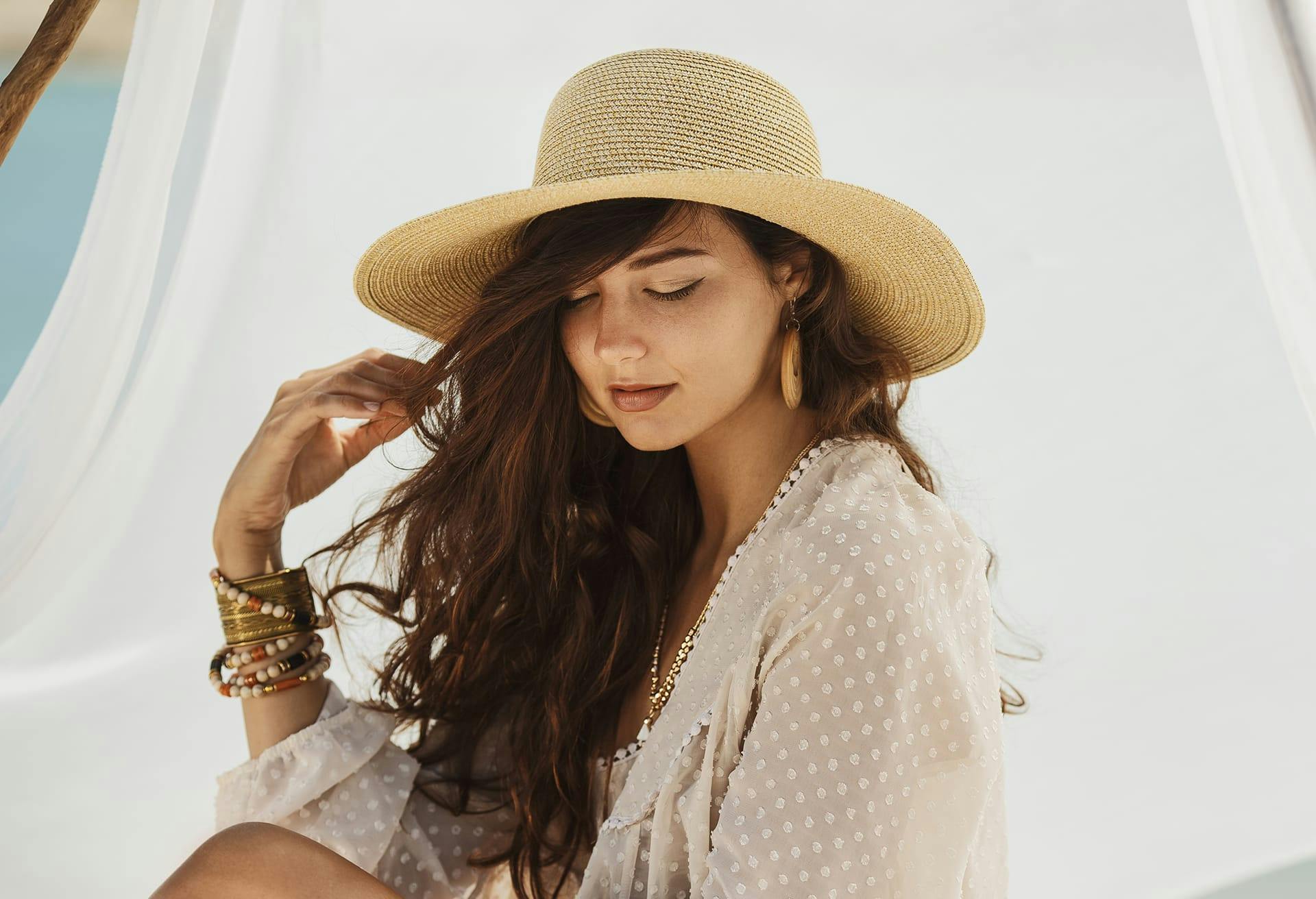 woman with hat on looking down