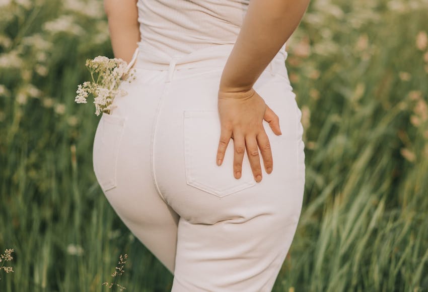 close up of woman's buttock in white jeans