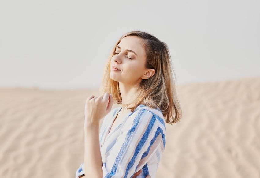 woman in striped long sleeve in sandy area