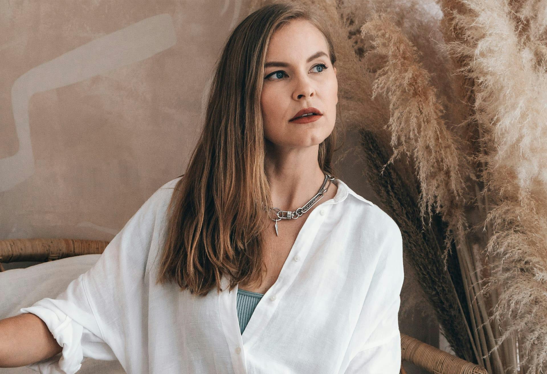 woman with straight hair looking to the side