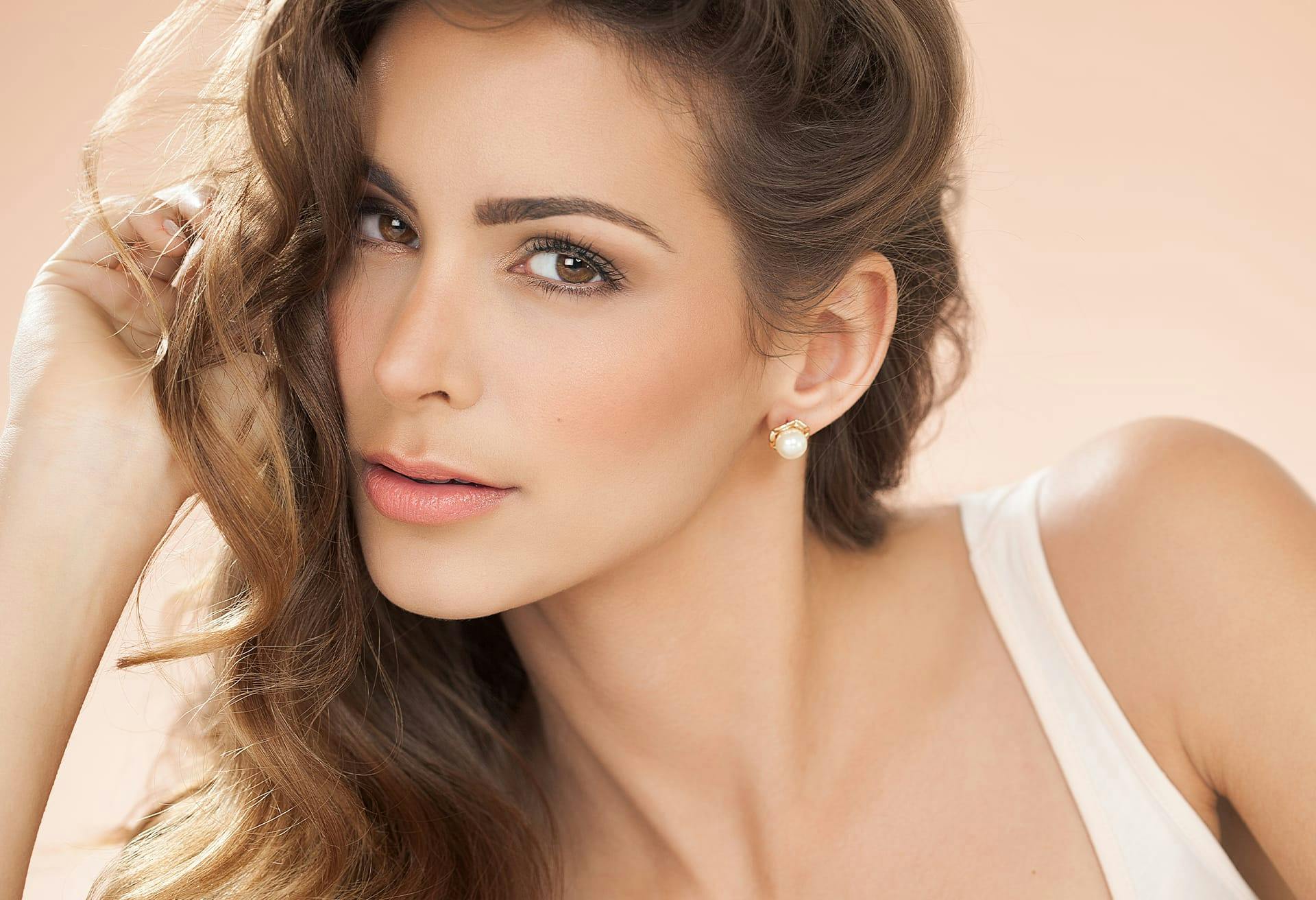 woman with her hair all on one side and looking forward