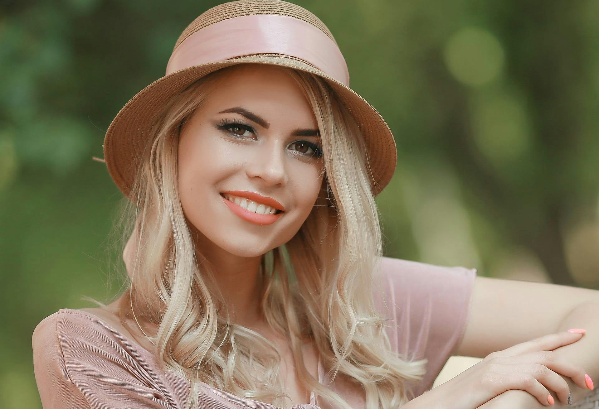 woman wearing hat and smiling