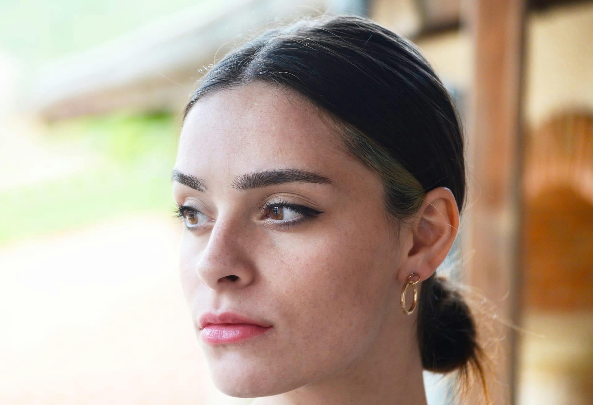 woman looking to the left with small ponytail