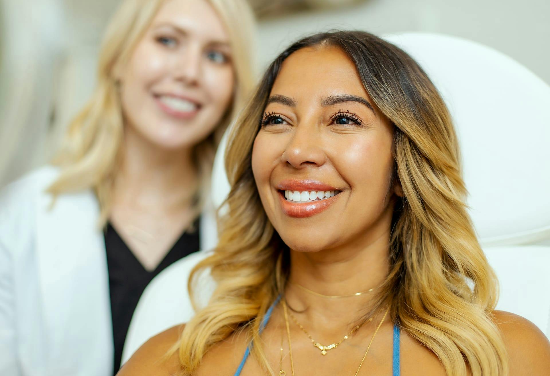 woman sitting in exam chair smiling