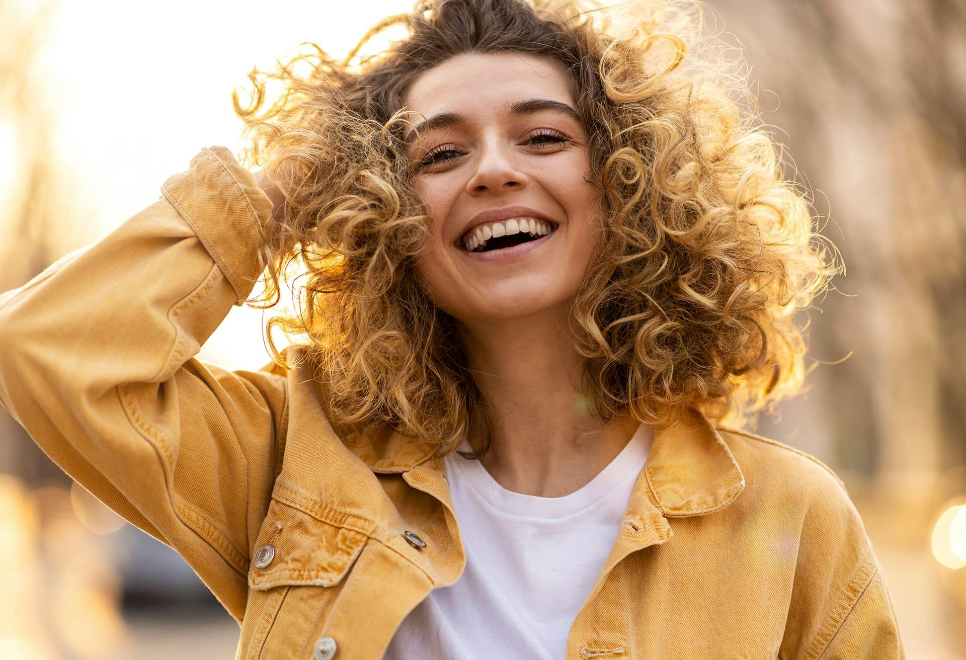 woman with curly hair smiling