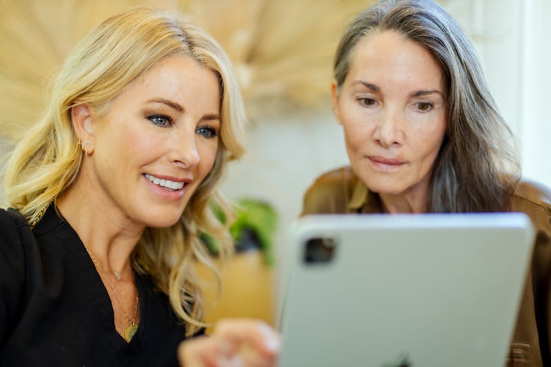 2 ladies looking at ipad together