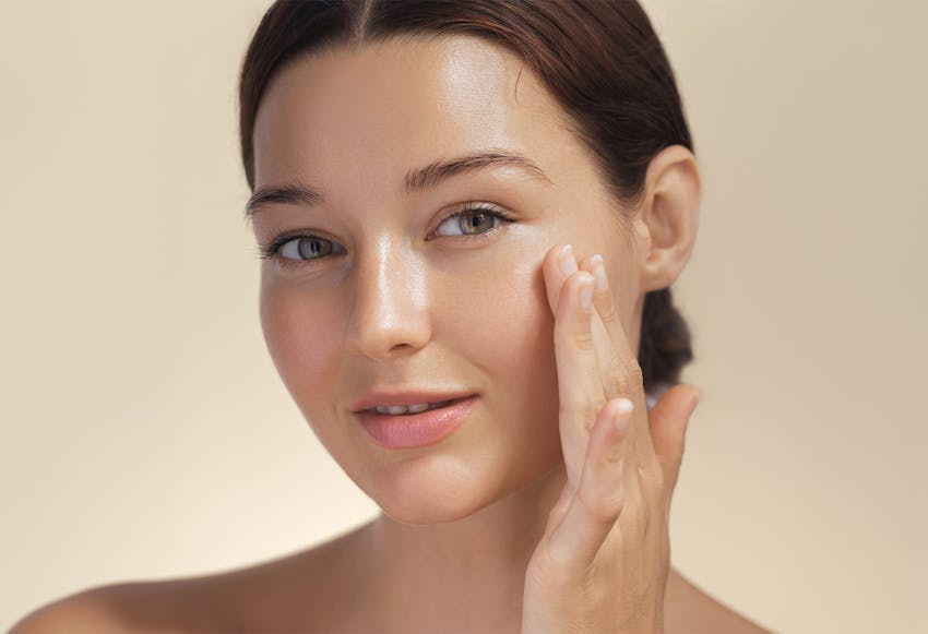 woman touching her cheek