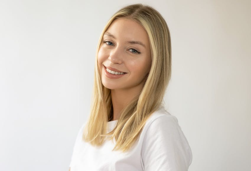 blonde woman with short hair in white shirt