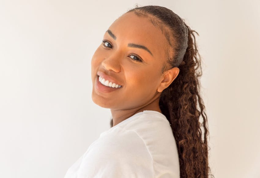 woman with long ponytail smiling