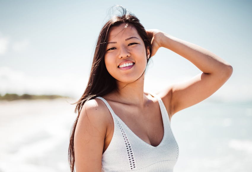 woman outside with hand on her head