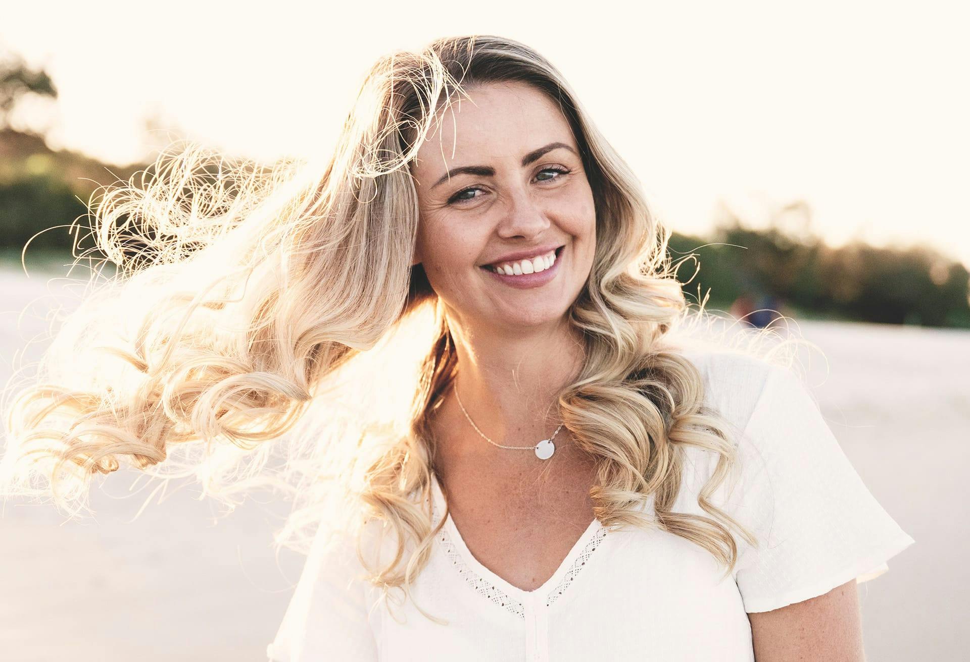 woman outside with hair flowing in the wind