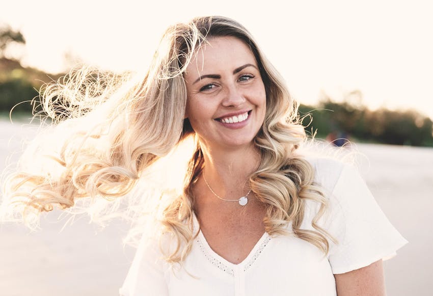 woman outside with hair flowing in the wind
