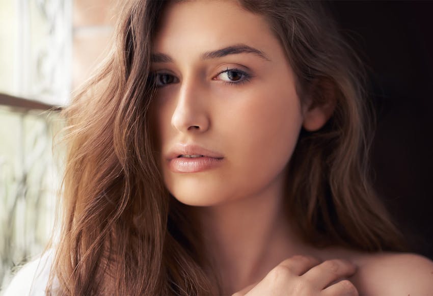 woman with long dark auburn hair