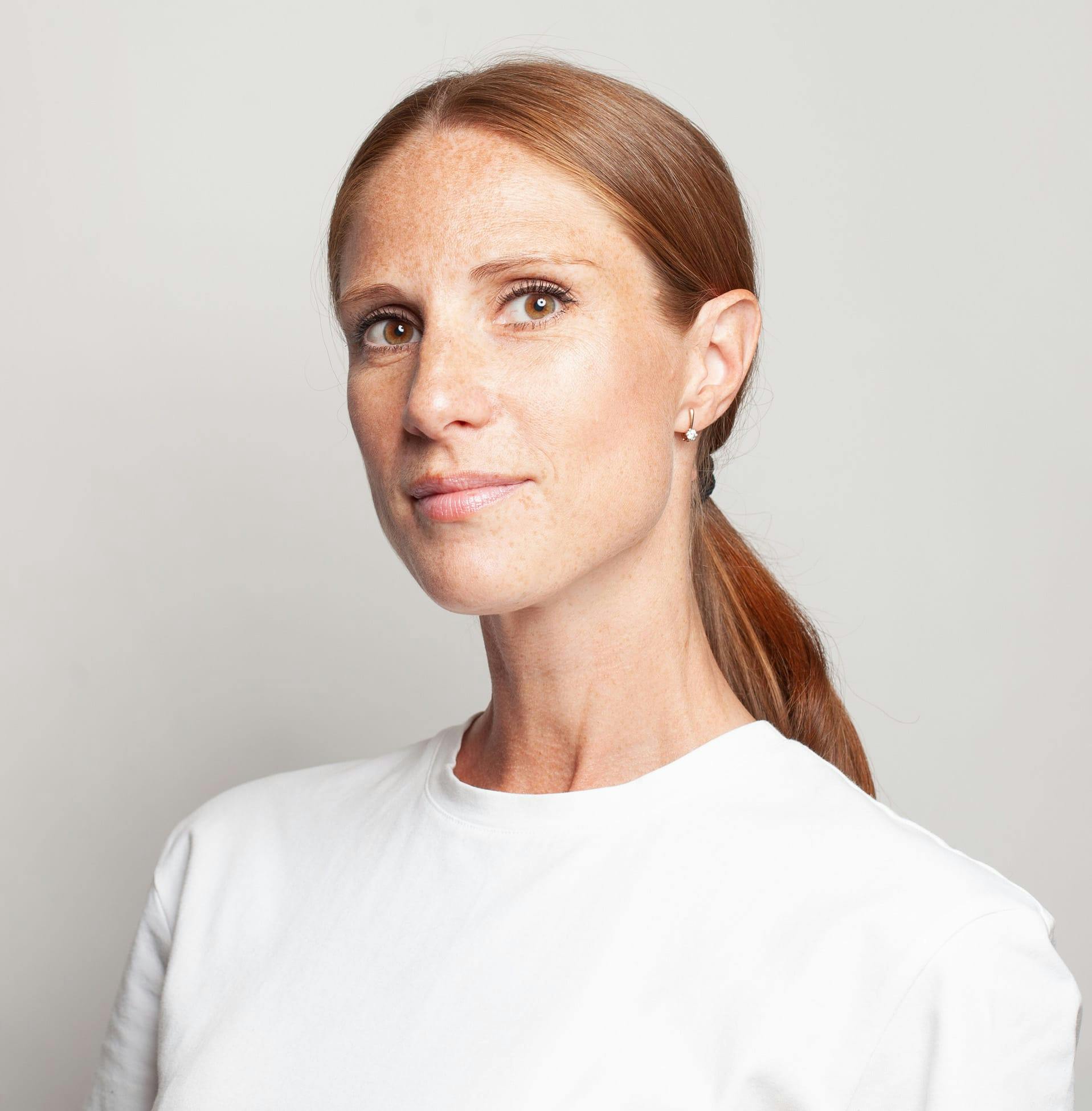 woman with ponytail wearing a white shirt