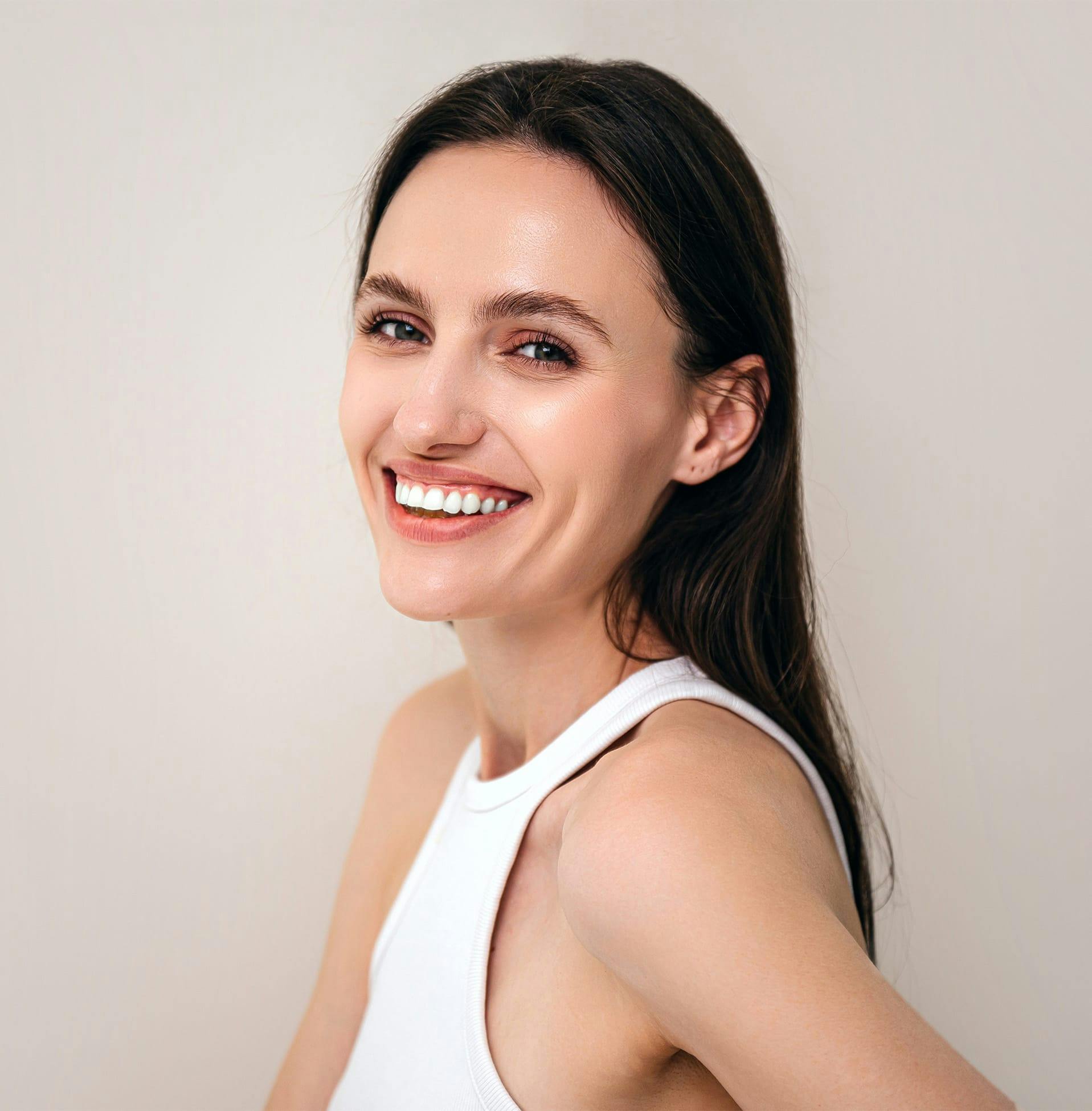 woman looking over her shoulder and smiling