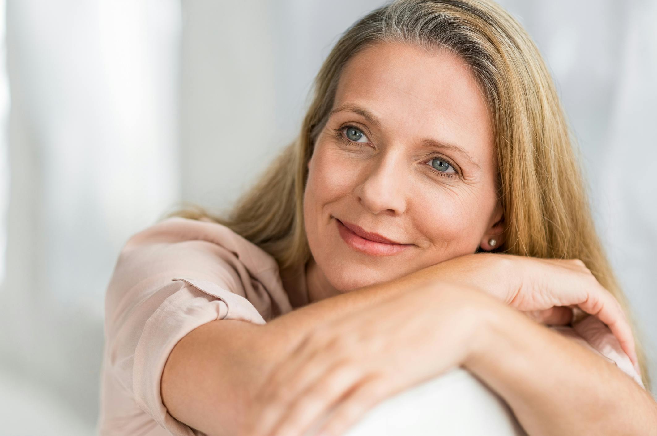 woman resting her head softly on a pillow
