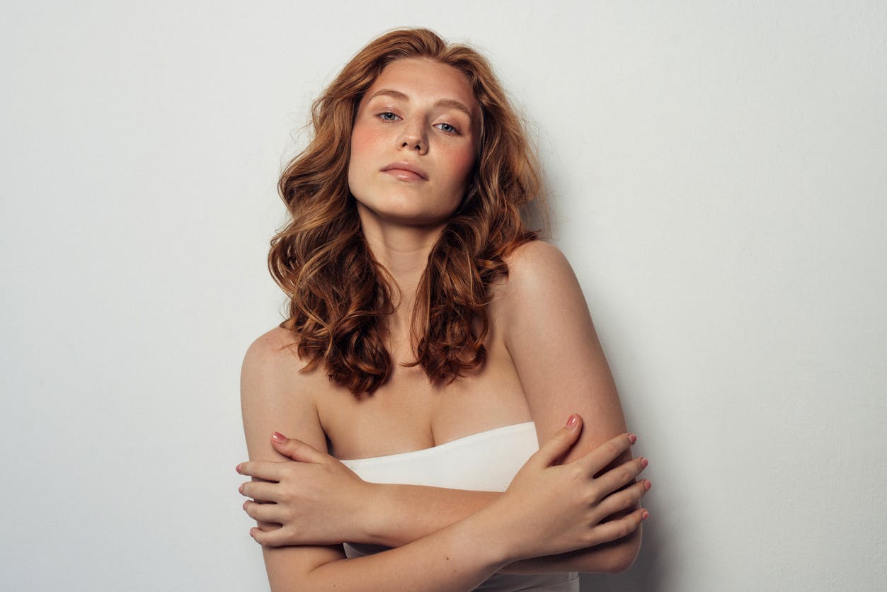 red haired woman in white tube top