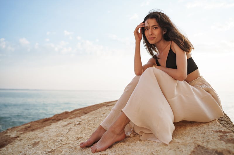 woman in linen pants on a rock
